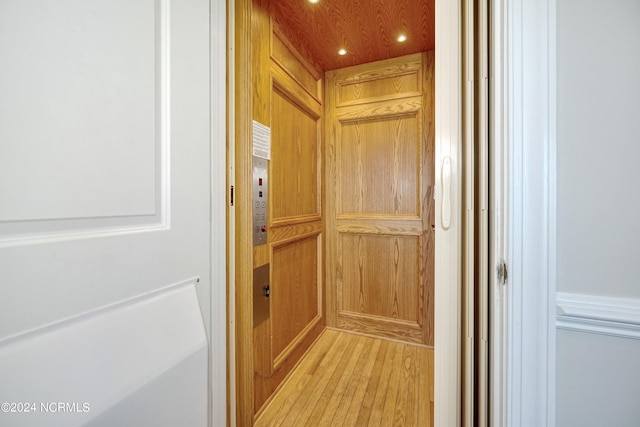 room details with elevator, wood finished floors, and recessed lighting