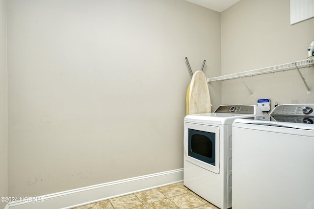 laundry area featuring laundry area, independent washer and dryer, and baseboards