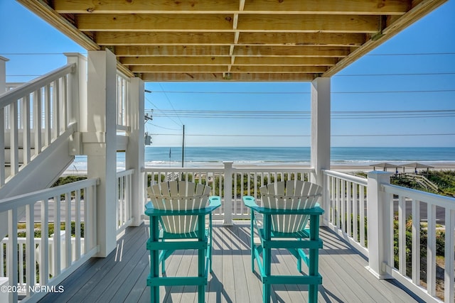 deck with a water view and a view of the beach