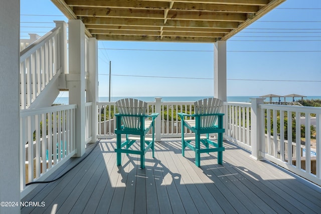 wooden terrace featuring a water view