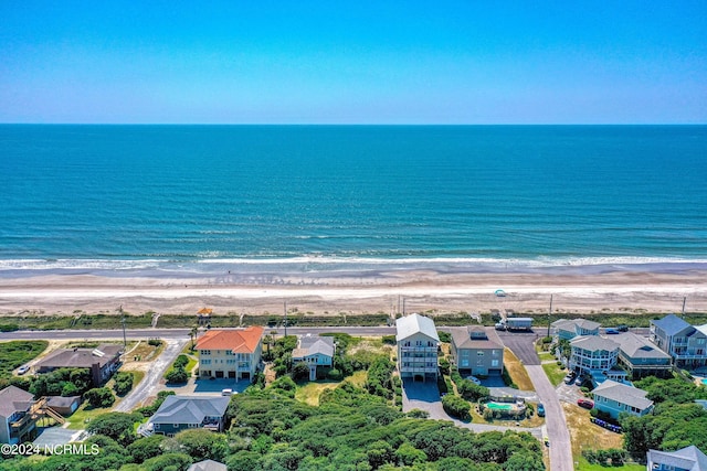 bird's eye view with a water view and a beach view