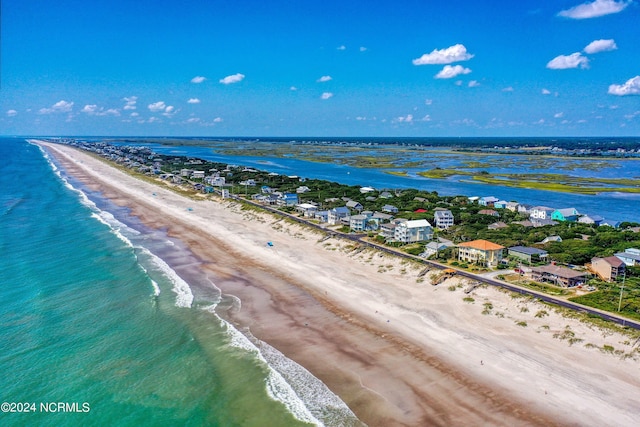 aerial view with a water view and a view of the beach