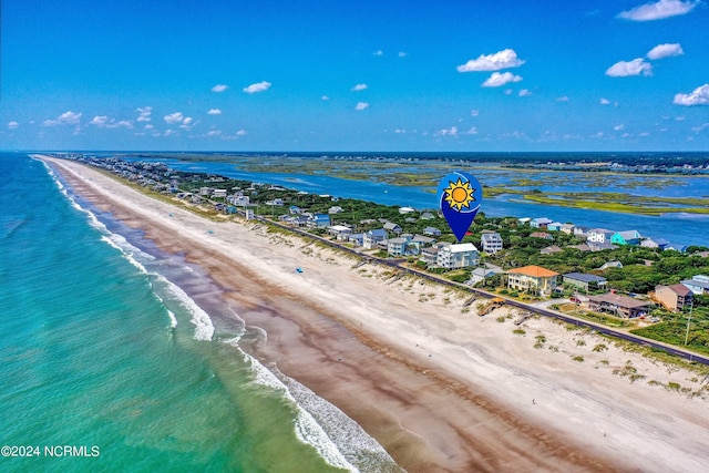 birds eye view of property with a view of the beach and a water view