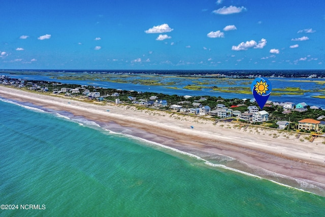 birds eye view of property featuring a water view and a beach view