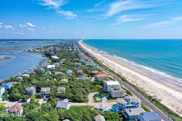 birds eye view of property with a beach view and a water view