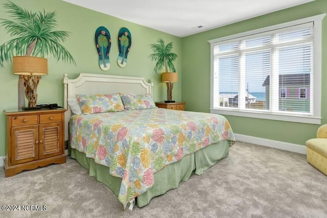 bedroom with carpet floors and baseboards