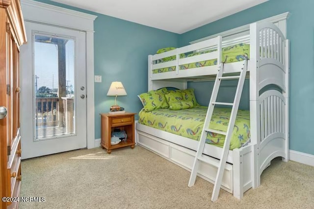 bedroom with access to outside, multiple windows, baseboards, and carpet flooring