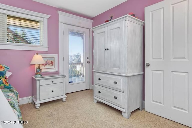 bedroom featuring access to outside and baseboards