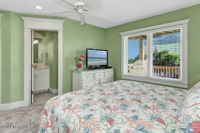 bedroom featuring ceiling fan, ensuite bathroom, and light carpet