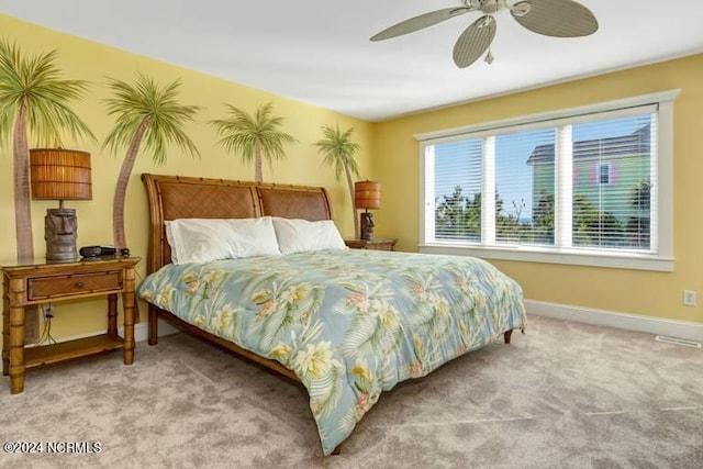 bedroom with ceiling fan, wallpapered walls, carpet, and baseboards