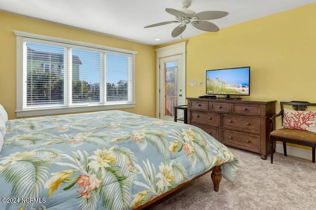 bedroom with light carpet, access to outside, and a ceiling fan