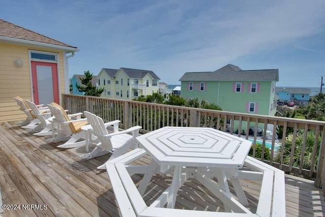 deck featuring a residential view and outdoor dining space