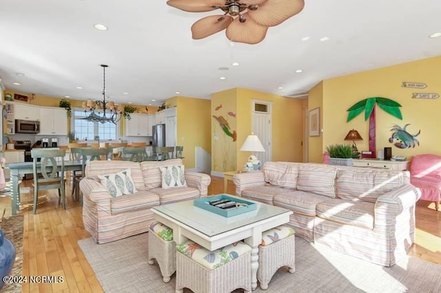 living room with ceiling fan and light hardwood / wood-style floors