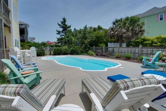 view of pool featuring a fenced backyard, a fenced in pool, and a patio