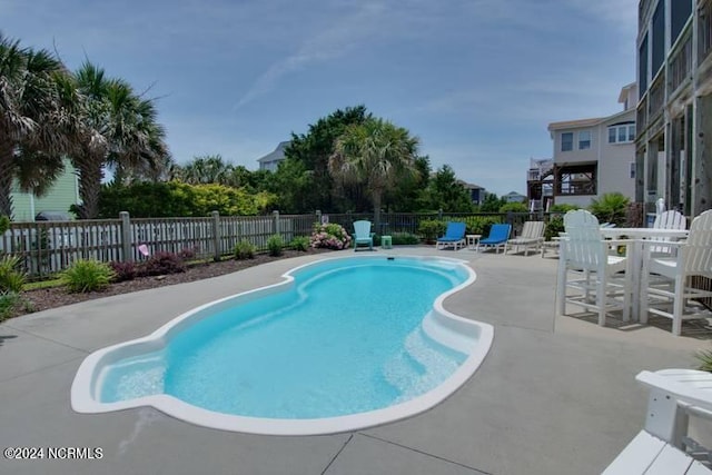 view of pool featuring a patio area, fence, and a fenced in pool