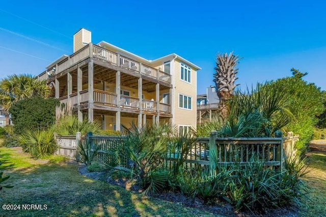 back of house featuring a balcony