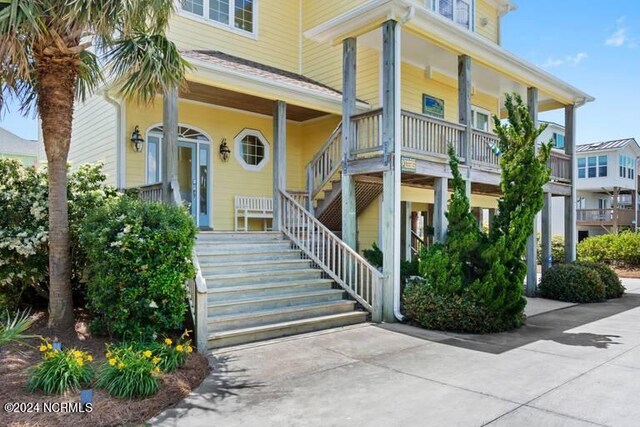 exterior space with stairs and a carport