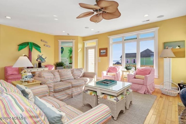 living room featuring visible vents, baseboards, wood-type flooring, ceiling fan, and recessed lighting