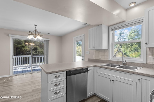 kitchen featuring dishwasher, a healthy amount of sunlight, white cabinetry, and sink