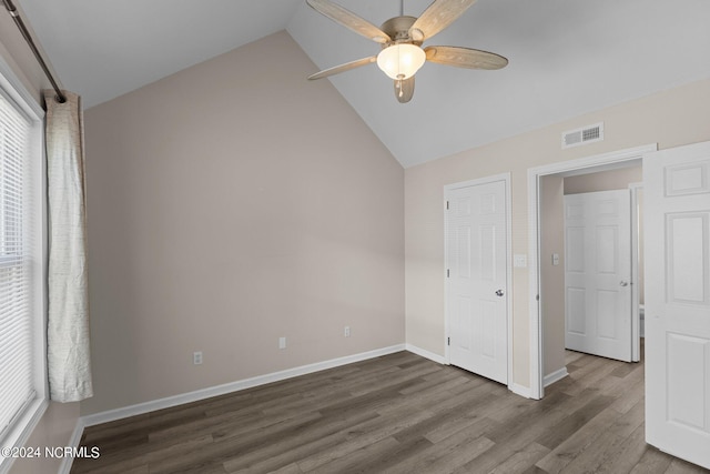 unfurnished bedroom with hardwood / wood-style flooring, ceiling fan, and lofted ceiling