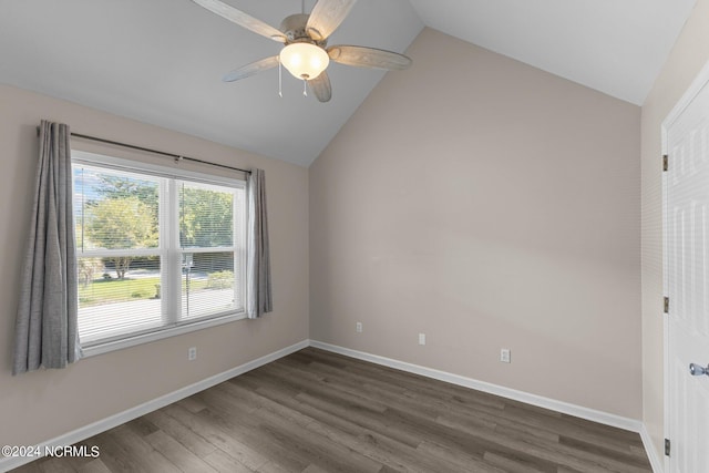 empty room featuring ceiling fan, dark hardwood / wood-style floors, and vaulted ceiling