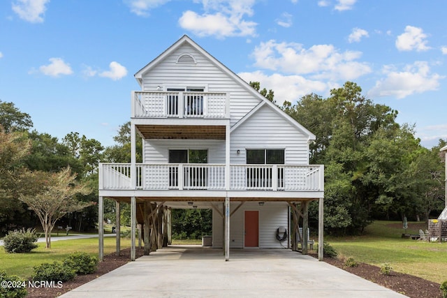 beach home with a front lawn and a carport