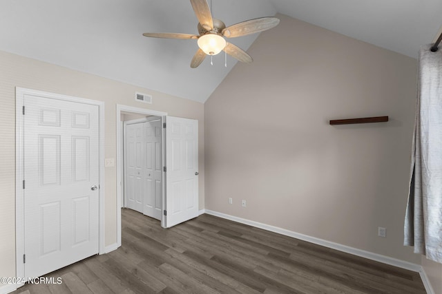 unfurnished bedroom featuring ceiling fan, dark wood-type flooring, and vaulted ceiling