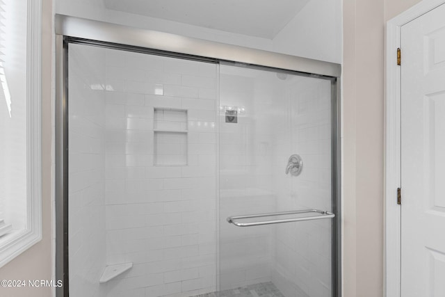 bathroom with a shower with shower door