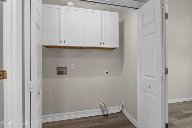 clothes washing area featuring hookup for an electric dryer, dark hardwood / wood-style flooring, cabinets, and washer hookup