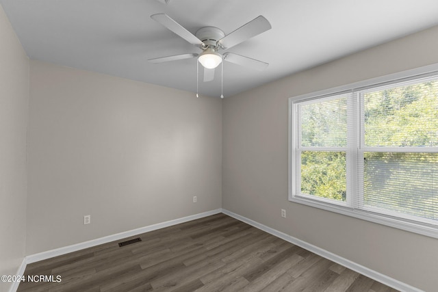 spare room featuring dark hardwood / wood-style floors and ceiling fan