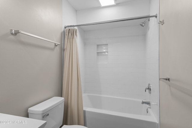 bathroom featuring shower / tub combo and toilet