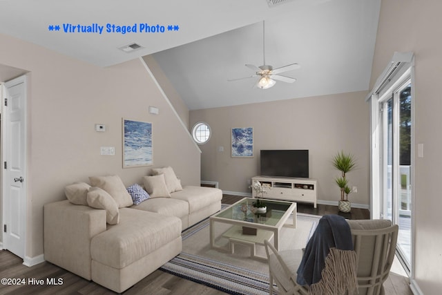 living room featuring dark hardwood / wood-style floors, high vaulted ceiling, and ceiling fan