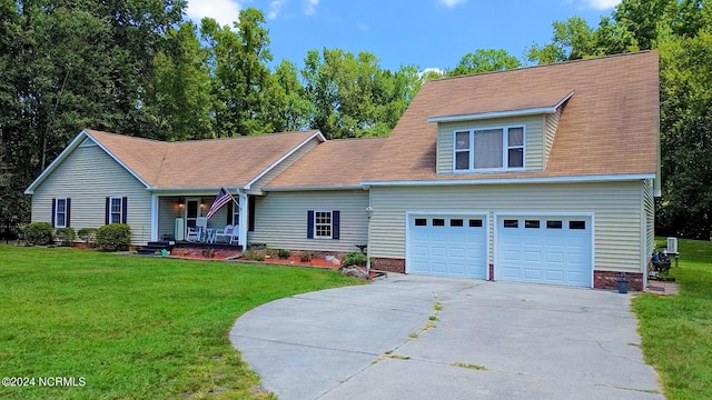 view of front facade with a garage, a porch, and a front yard