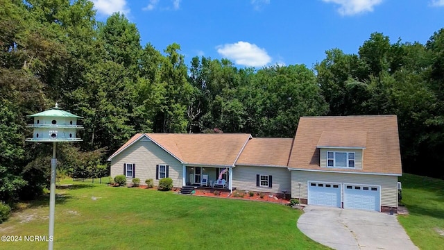 view of front of home with a porch, a garage, and a front lawn