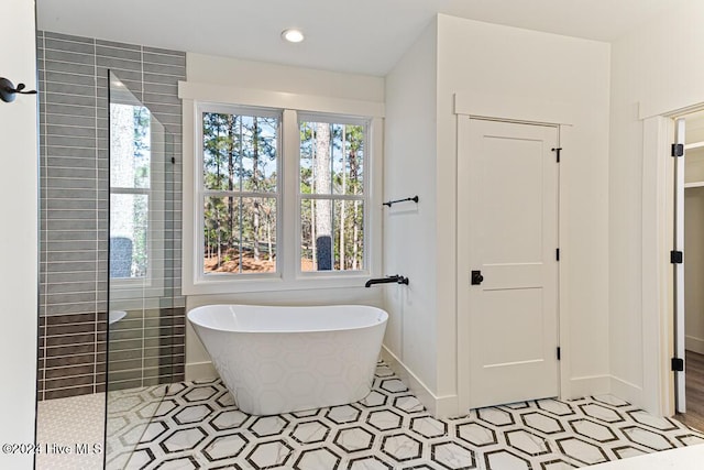 bathroom featuring tile patterned floors and shower with separate bathtub