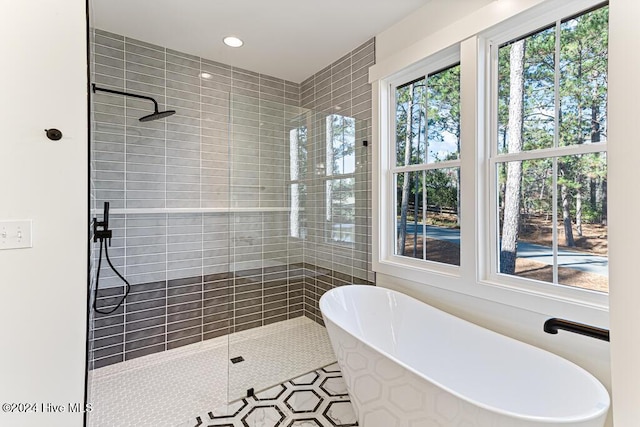 bathroom with tile patterned flooring and independent shower and bath