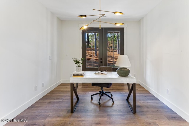 home office with an inviting chandelier, dark wood-type flooring, and french doors