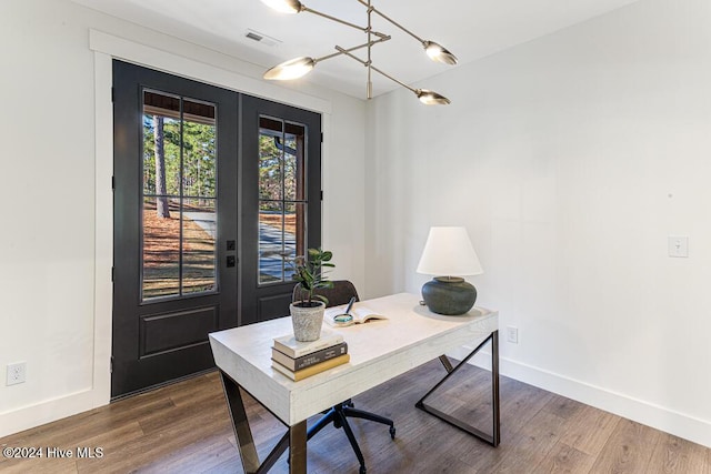 home office featuring hardwood / wood-style floors and french doors