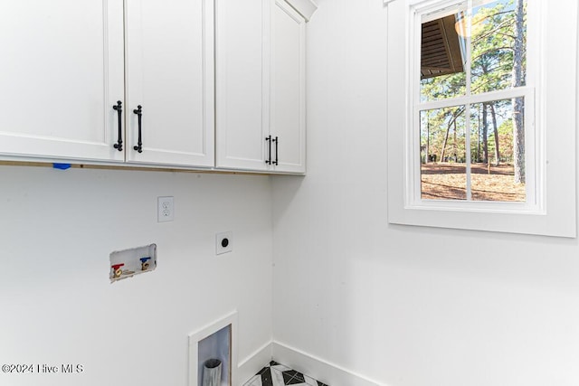 clothes washing area featuring hookup for an electric dryer, cabinets, and hookup for a washing machine