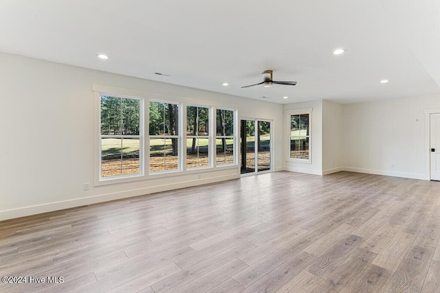 unfurnished living room featuring ceiling fan and light wood-type flooring