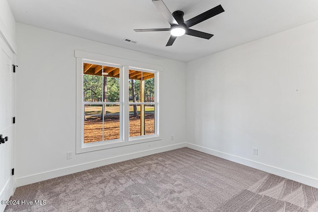 empty room with ceiling fan and light colored carpet