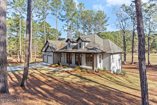 view of front of home with covered porch and a garage