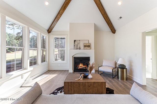 living room with hardwood / wood-style floors and lofted ceiling with beams