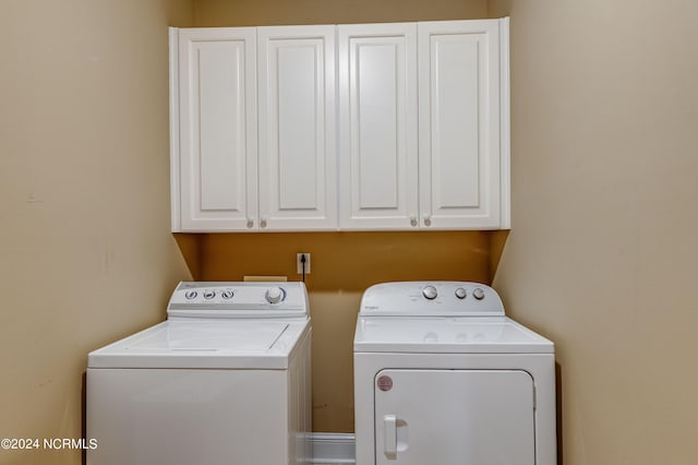 laundry room featuring cabinets and washer and dryer