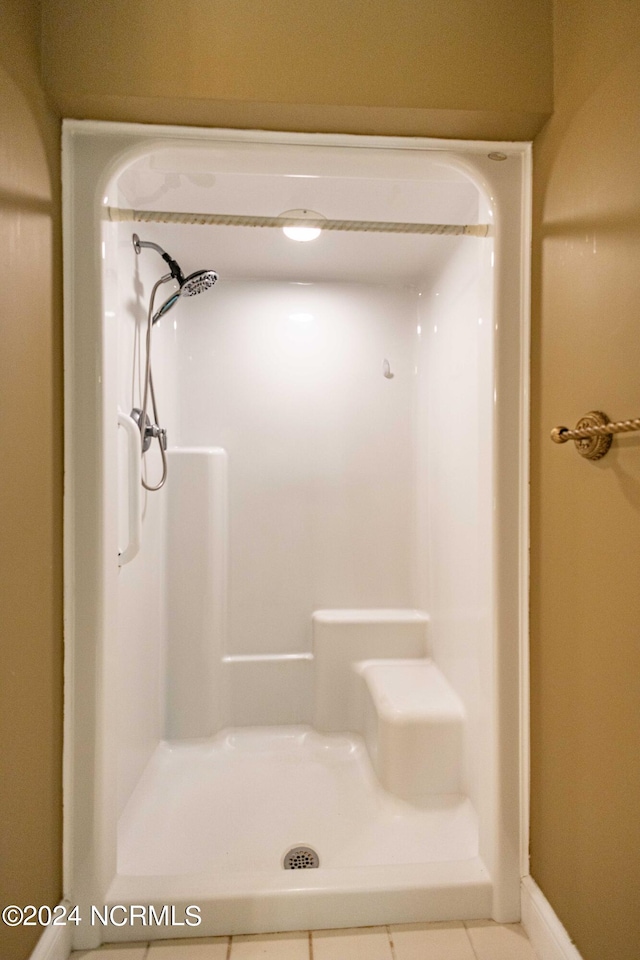 bathroom with walk in shower and tile patterned floors