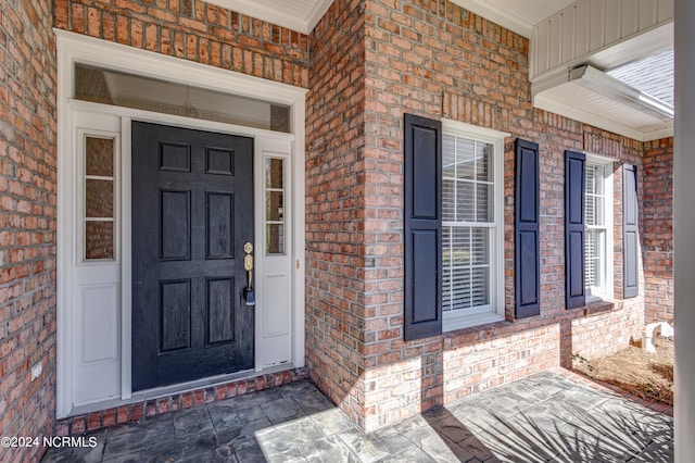 view of exterior entry with covered porch