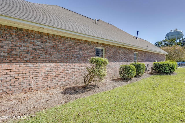 view of side of property with a yard