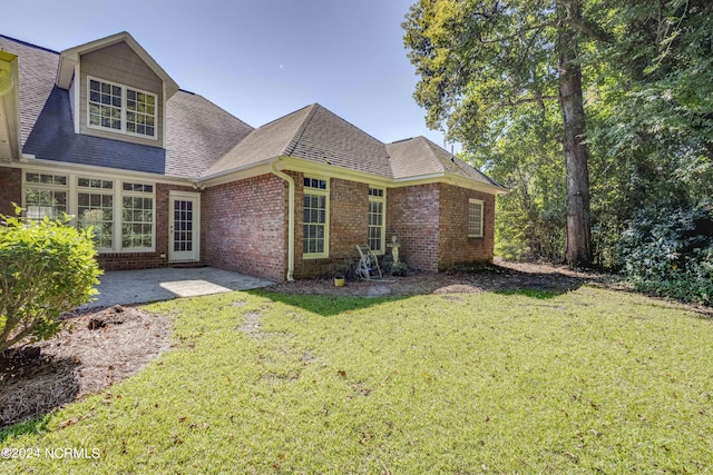 view of front of house with a patio and a front lawn