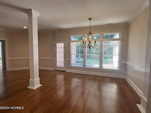 interior space featuring a healthy amount of sunlight, dark hardwood / wood-style floors, a chandelier, and ornate columns