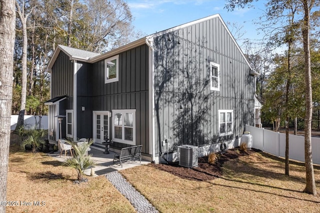 exterior space featuring central AC unit, a patio area, and a lawn